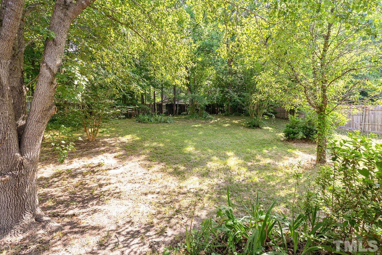5708 Brandycrest Drive Raleigh, NC 27610 - Photo 25 of 31 a backyard of a house with lots of green space