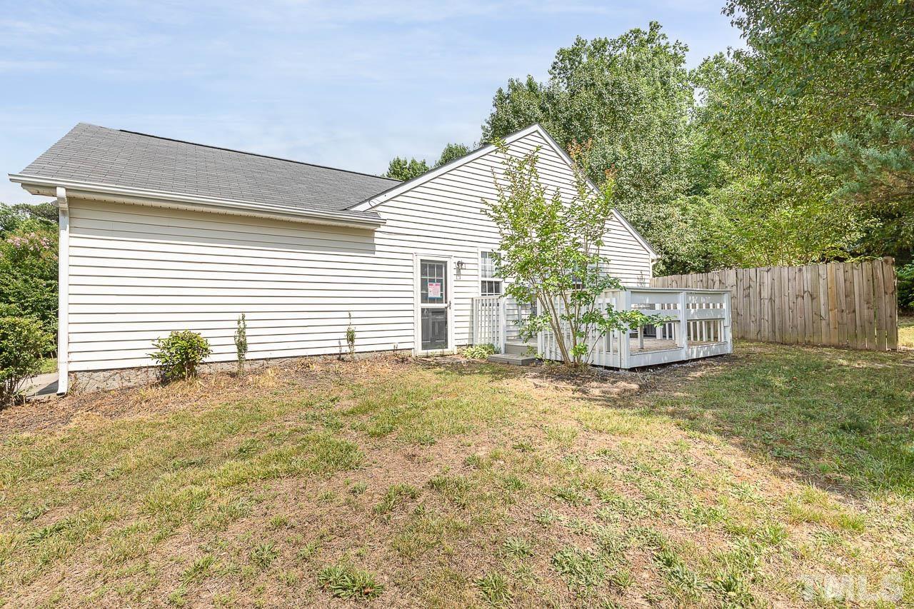 5708 Brandycrest Drive Raleigh, NC 27610 - Photo 30 of 31 a view of a house with a yard and garage