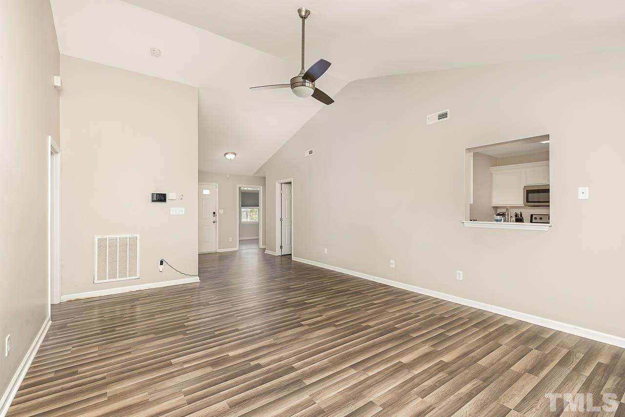 5708 Brandycrest Drive Raleigh, NC 27610 - Photo 6 of 31 a view of a room with wooden floor and a ceiling fan