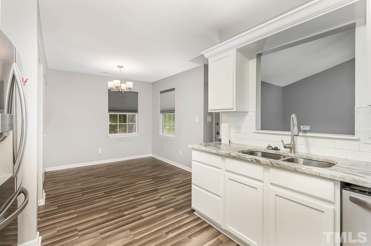 5708 Brandycrest Drive Raleigh, NC 27610 - Photo 10 of 31 a kitchen with a sink cabinets and window