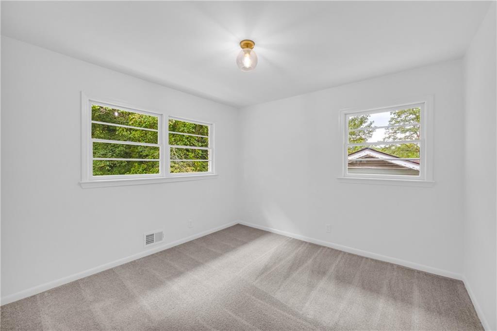 2678 Rainbow Forest Drive Decatur, GA 30034 - Photo 38 of 48 an empty room with windows and bed
