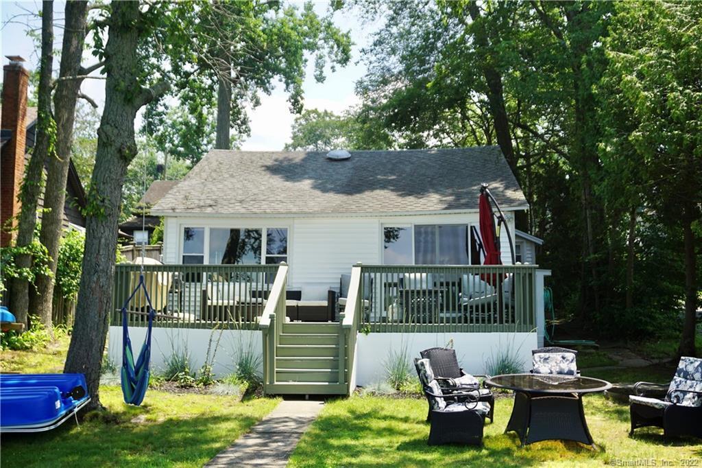 a front view of a house with a yard table and chairs