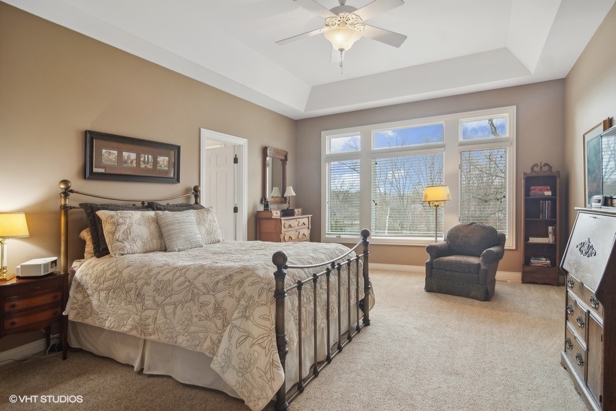 91 Roberts Road Inverness, IL 60067 - Photo 12 of 36 a bedroom with a bed and a chandelier