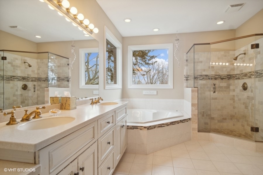 91 Roberts Road Inverness, IL 60067 - Photo 13 of 36 a bathroom with a tub sink shower and mirror