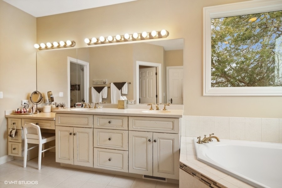 91 Roberts Road Inverness, IL 60067 - Photo 14 of 36 a bathroom with a double vanity sink and a mirror