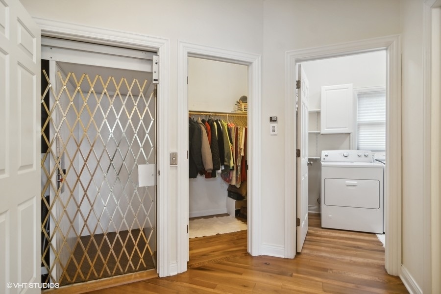 91 Roberts Road Inverness, IL 60067 - Photo 17 of 36 a view of walk in closet with wooden floor and closet