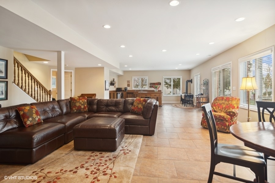 91 Roberts Road Inverness, IL 60067 - Photo 19 of 36 a living room with furniture a wooden floor and a chandelier