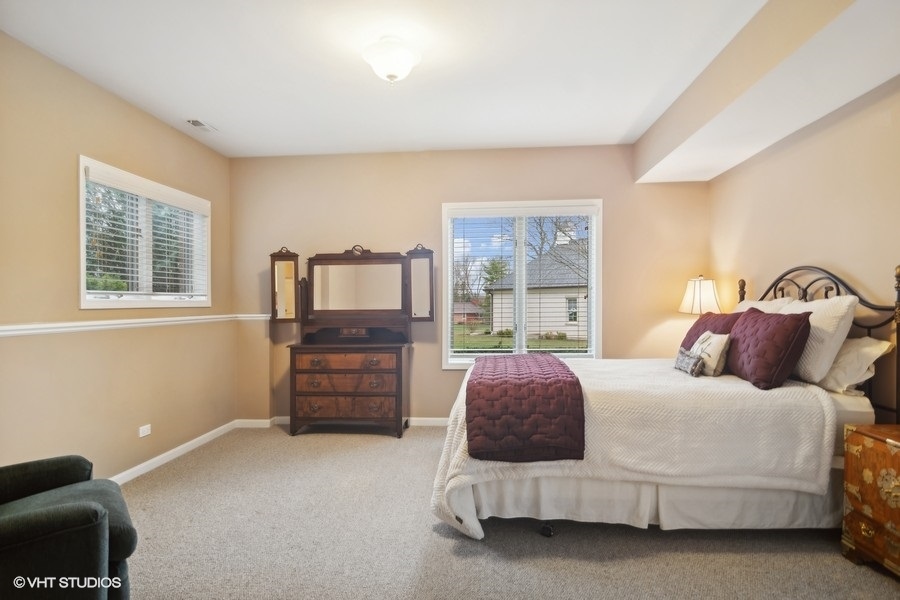 91 Roberts Road Inverness, IL 60067 - Photo 23 of 36 a bedroom with a bed and wooden floor