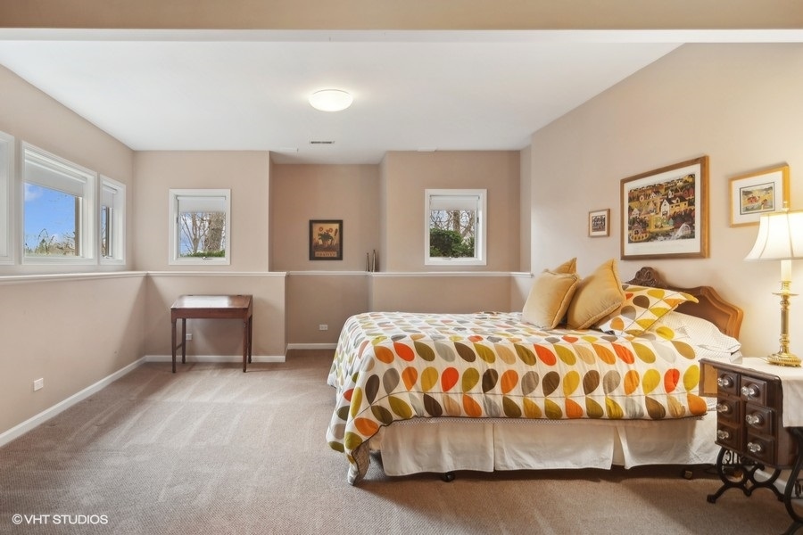 91 Roberts Road Inverness, IL 60067 - Photo 25 of 36 a bedroom with a large bed and a couch