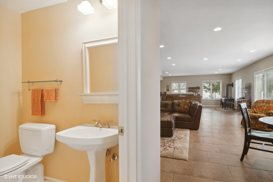 91 Roberts Road Inverness, IL 60067 - Photo 26 of 36 a bathroom with a sink a toilet and a mirror