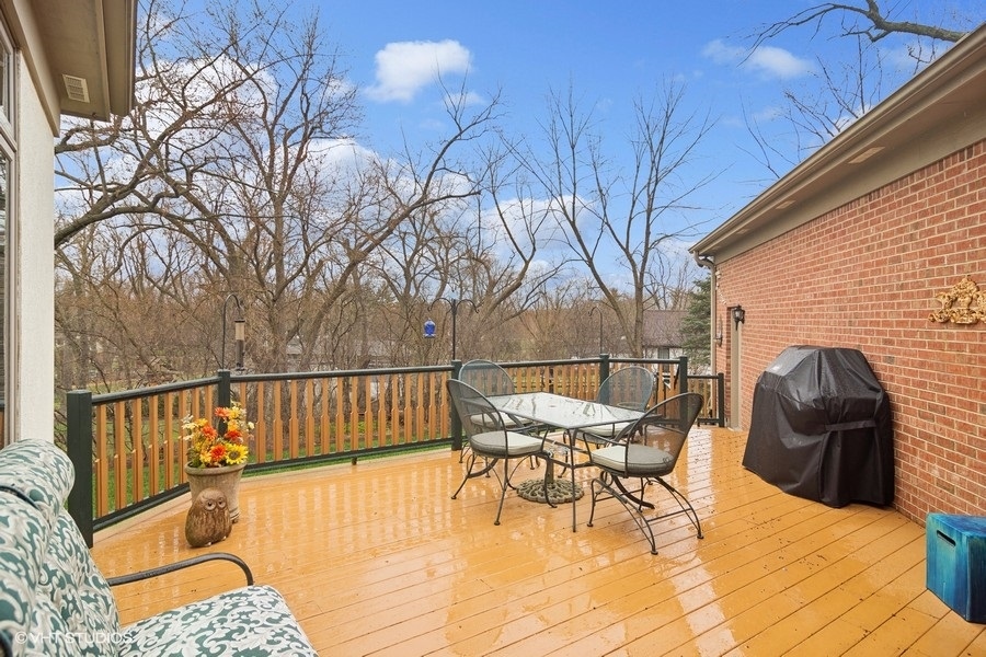 91 Roberts Road Inverness, IL 60067 - Photo 27 of 36 a view of a roof deck with table and chairs and wooden floor