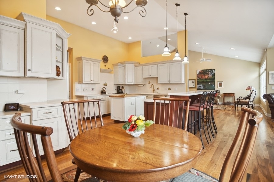 91 Roberts Road Inverness, IL 60067 - Photo 8 of 36 a view of a dining room with furniture a kitchen and chandelier