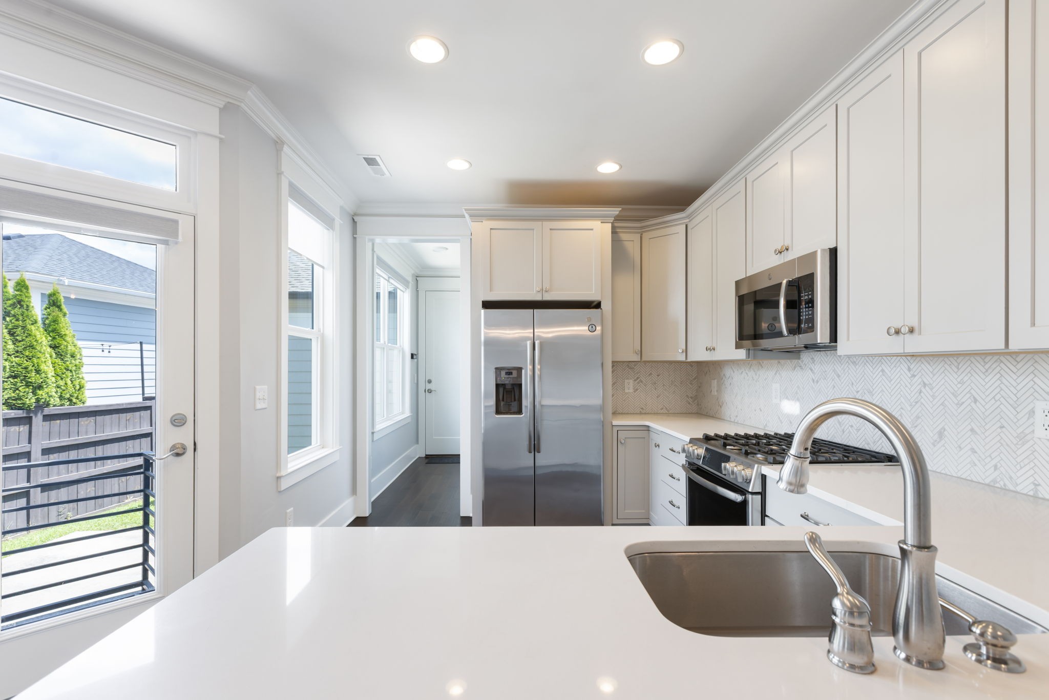 3091 Cheever Street Franklin, TN 37064 - Photo 17 of 36 a kitchen with stainless steel appliances kitchen island granite countertop a refrigerator and microwave