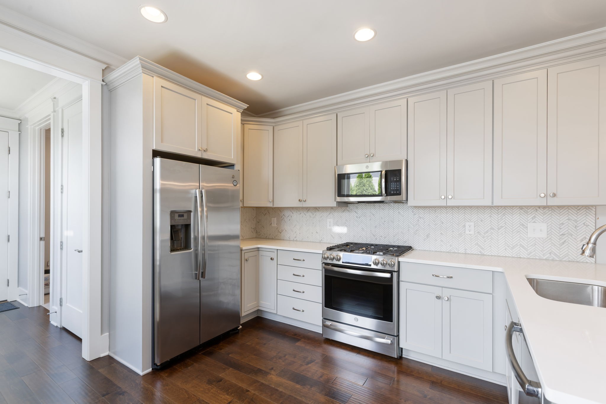 3091 Cheever Street Franklin, TN 37064 - Photo 18 of 36 a kitchen with white cabinets and stainless steel appliances