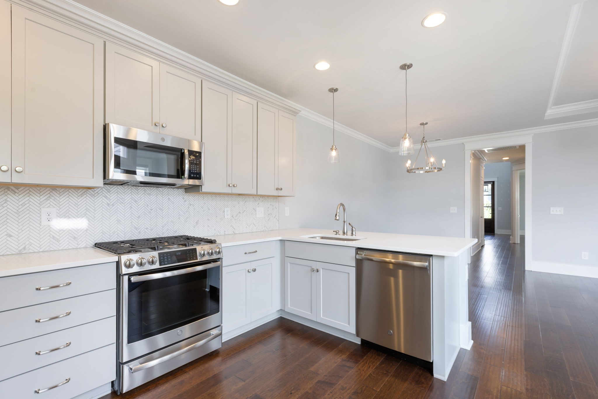3091 Cheever Street Franklin, TN 37064 - Photo 20 of 36 a kitchen with stainless steel appliances granite countertop a stove a sink and white cabinets with wooden floor