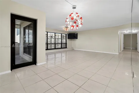 a view of a big room with kitchen and chandelier