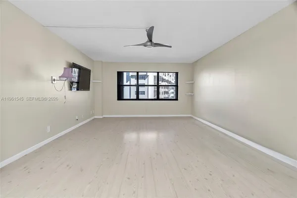a living room with furniture a large window with outer view