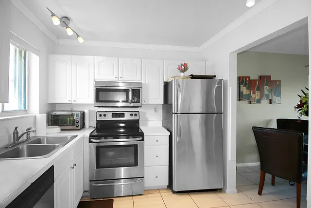 a kitchen with a refrigerator stove and microwave