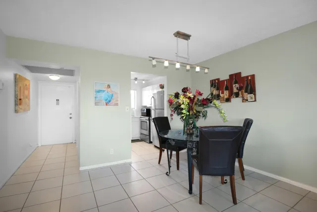 a view of a dining room with furniture and chandelier