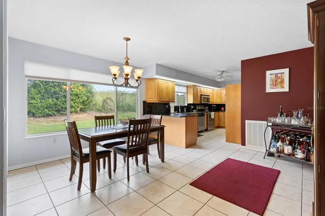 a view of a dining room with furniture and chandelier