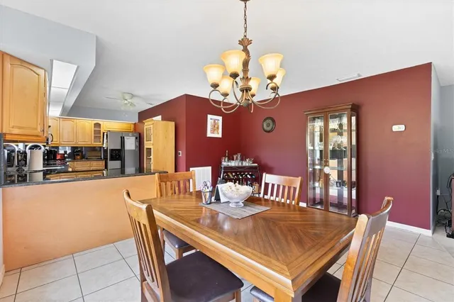 a large kitchen with granite countertop a stove a sink a window and stainless steel appliances
