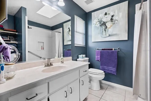 a bed room with a bed and a night stand