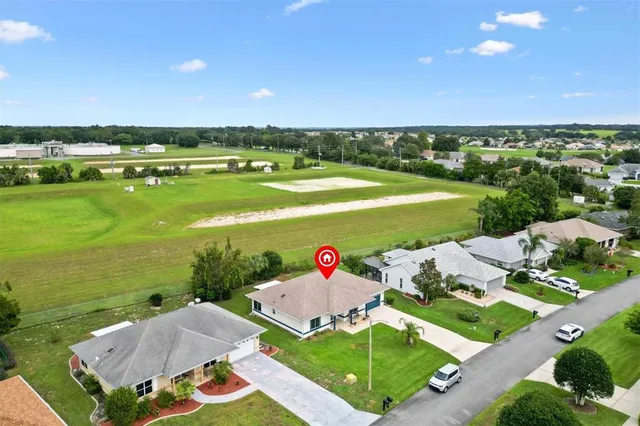 an aerial view of house with yard swimming pool and outdoor seating