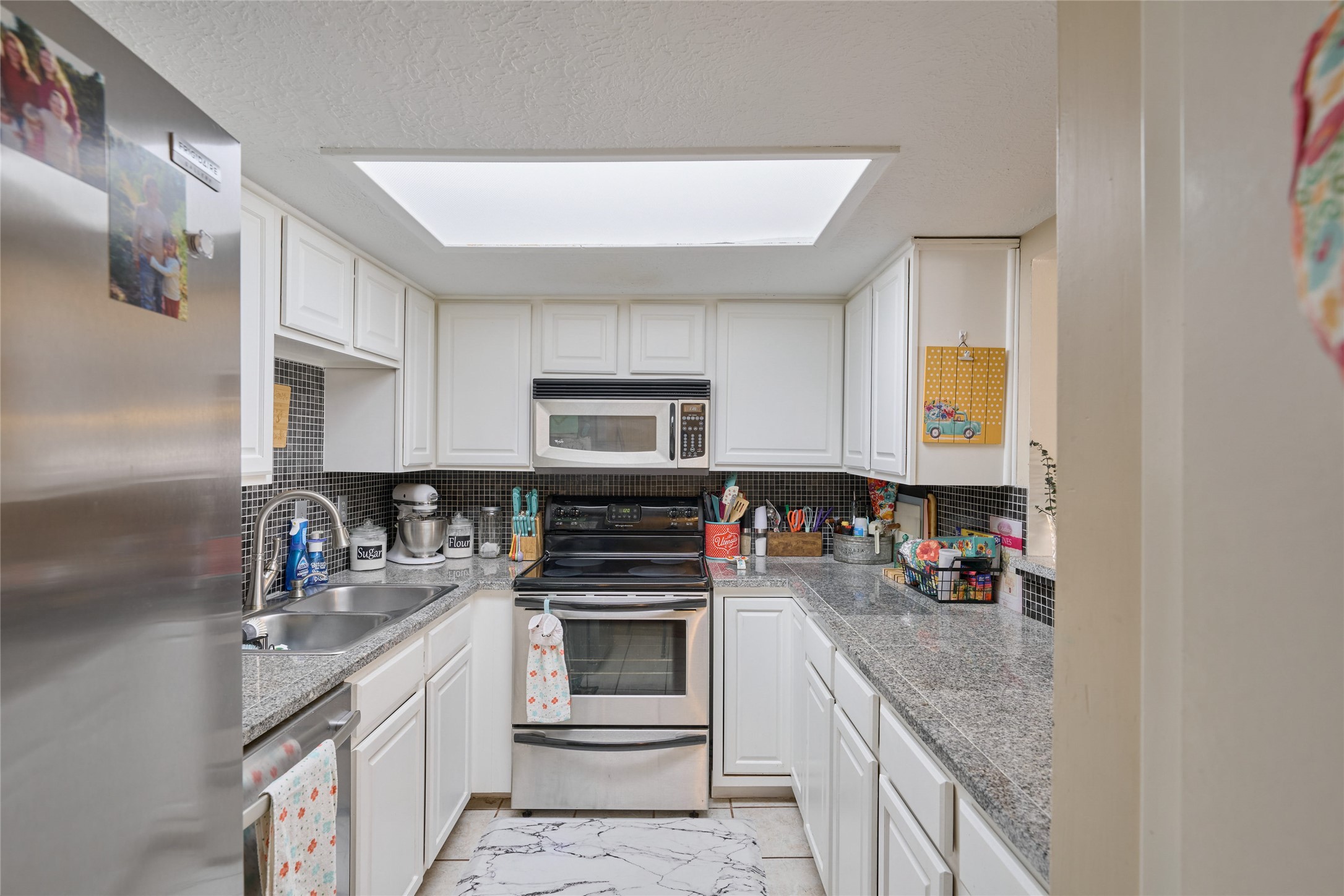 39 Regency Point Montgomery, TX 77356 - Photo 28 of 43 a kitchen with stainless steel appliances granite countertop a sink stove and cabinets