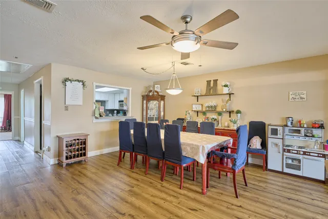 a view of a dining room with furniture and wooden floor