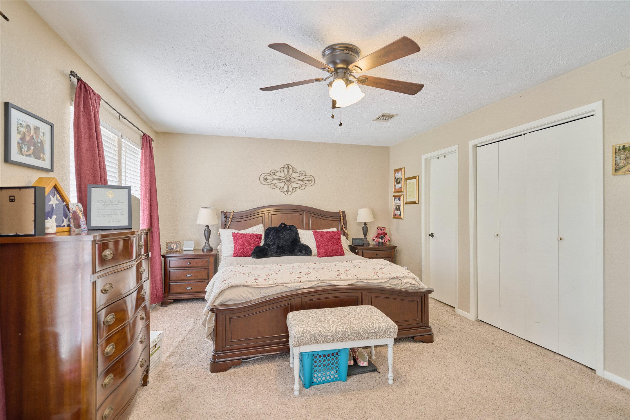39 Regency Point Montgomery, TX 77356 - Photo 38 of 43 a bedroom with a bed and a chandelier