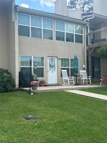 a view of a house with backyard sitting area and garden