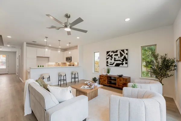 a living room with furniture and a wooden floor