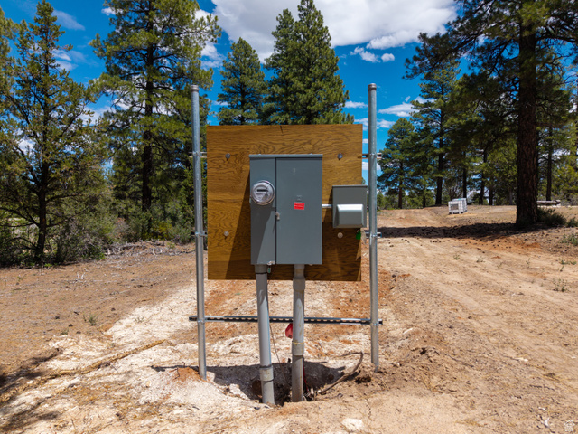 295 South White Oak Street, Unit 8AD2 Orderville, UT 84758 - Photo 7 of 7 Utility pedestal with electrical meter and service panel, set against a backdrop of mature pine trees and a clear blue sky