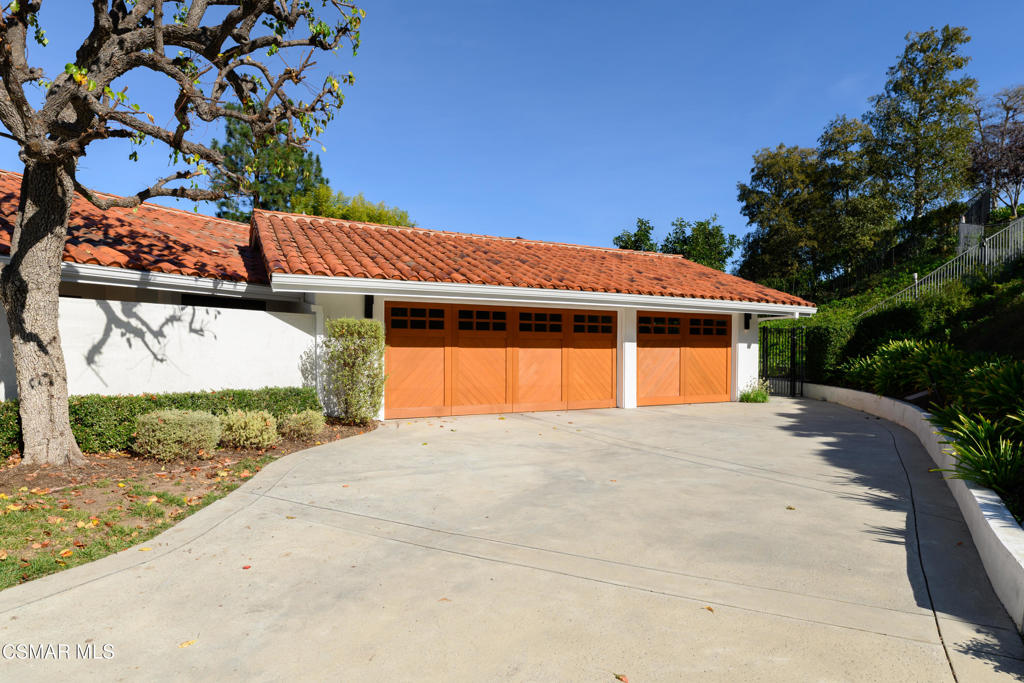 87 Pinecrest Road Westlake Village, CA 91361 - Photo 15 of 76 a front view of a house with a yard and garage