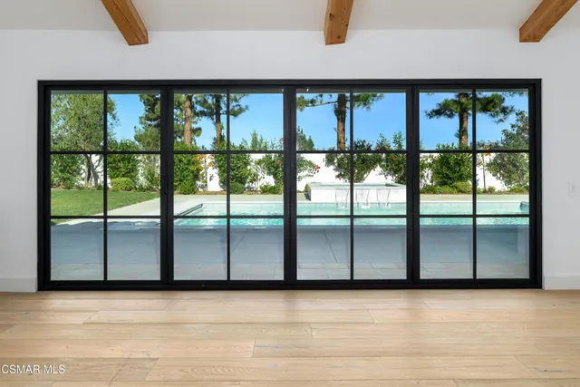 a bedroom with a bed and a large window