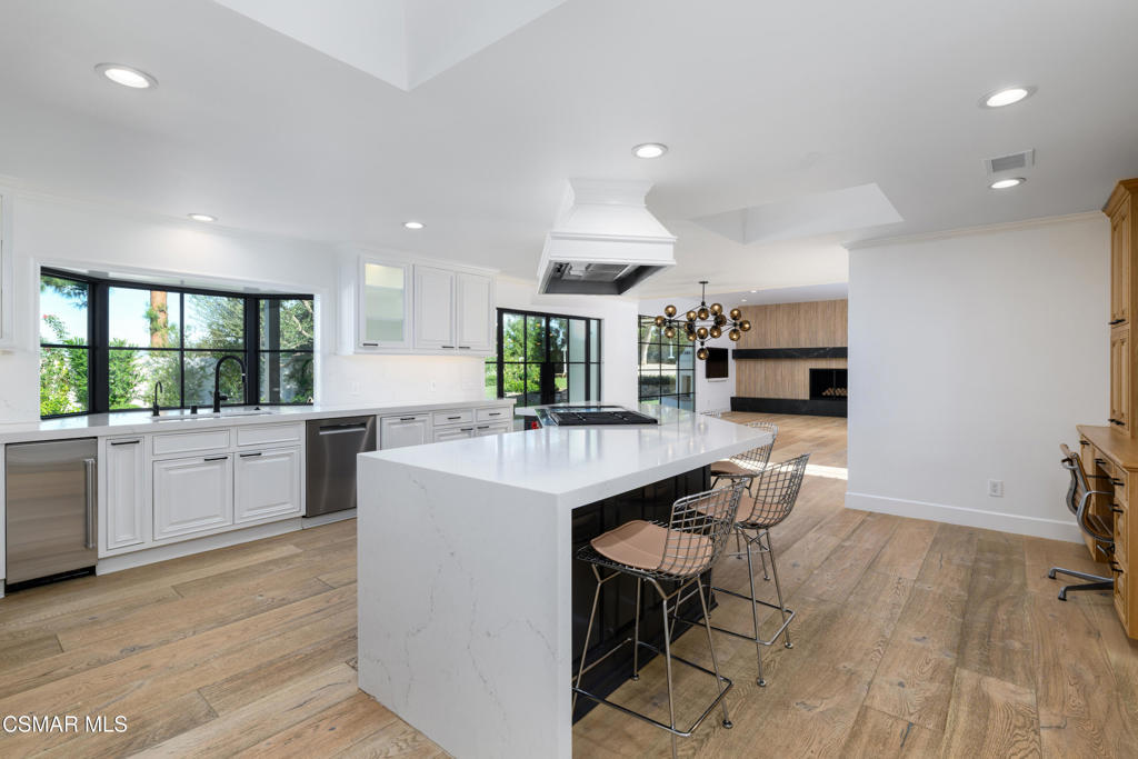 87 Pinecrest Road Westlake Village, CA 91361 - Photo 35 of 76 a kitchen with stainless steel appliances kitchen island wooden cabinets and granite counter tops