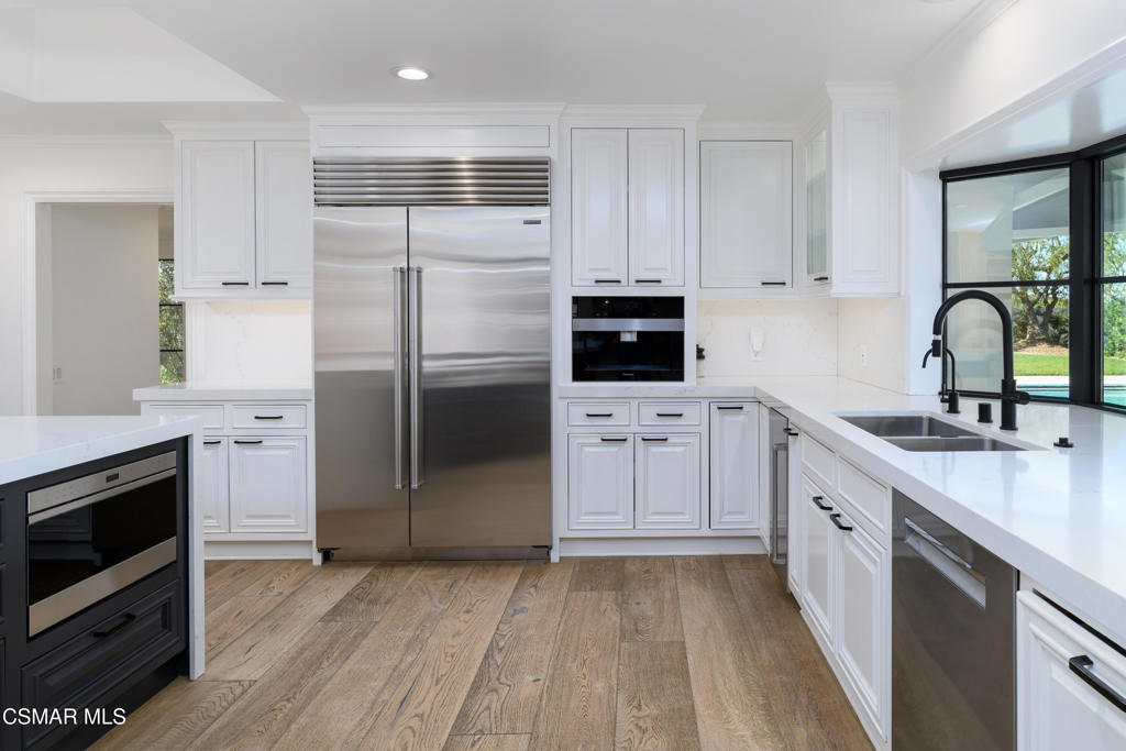 87 Pinecrest Road Westlake Village, CA 91361 - Photo 39 of 76 a kitchen with white cabinets and stainless steel appliances