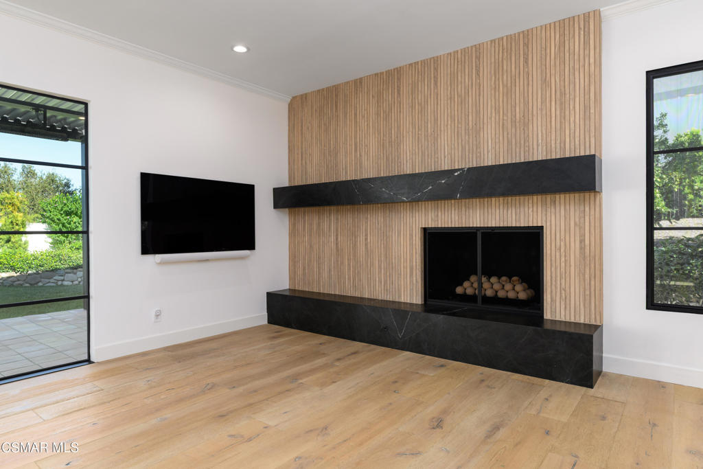 87 Pinecrest Road Westlake Village, CA 91361 - Photo 45 of 76 a living room with a fireplace a flat screen tv and a fireplace