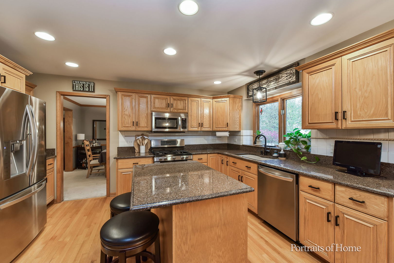 1813 Marne Road Bolingbrook, IL 60490 - Photo 9 of 30 a kitchen with stainless steel appliances granite countertop a sink a stove and a refrigerator