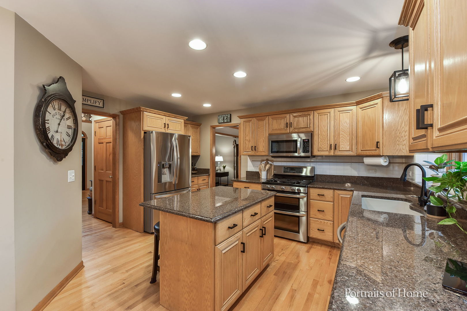 1813 Marne Road Bolingbrook, IL 60490 - Photo 10 of 30 a kitchen with stainless steel appliances granite countertop a stove a sink a refrigerator and a microwave