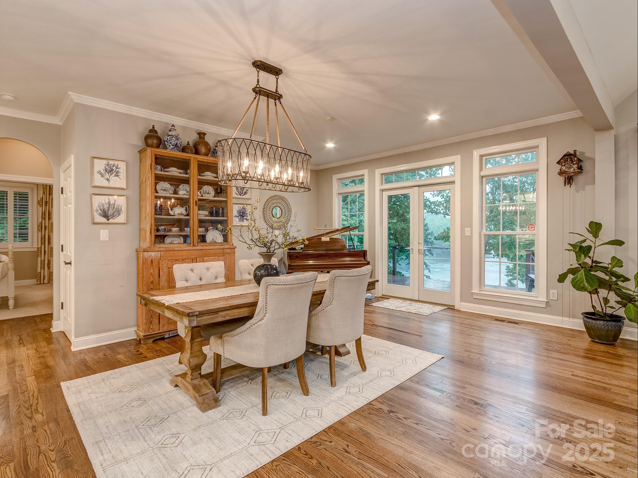 5951 Johnson Road Clover, SC 29710 - Photo 16 of 48 a dining room with wooden floor a chandelier a glass table and chairs