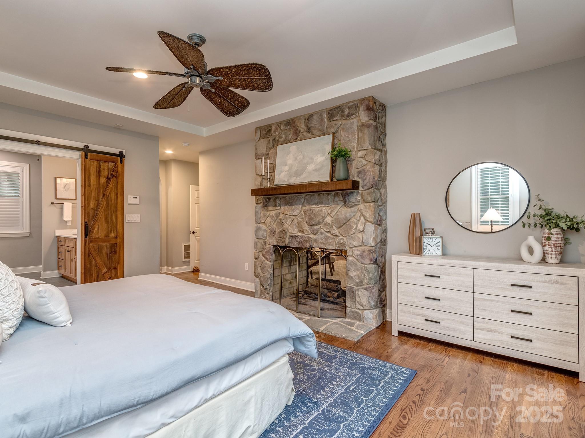 5951 Johnson Road Clover, SC 29710 - Photo 24 of 48 a spacious bedroom with a bed and a chandelier