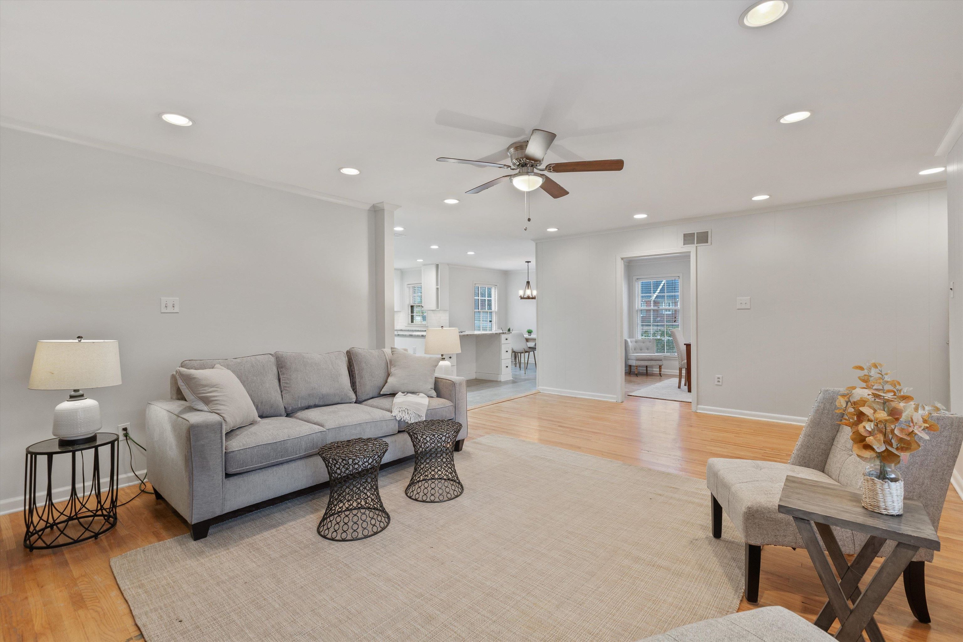 5555 Barfield Road Memphis, TN 38120 - Photo 11 of 23 a living room with furniture a rug and a chandelier