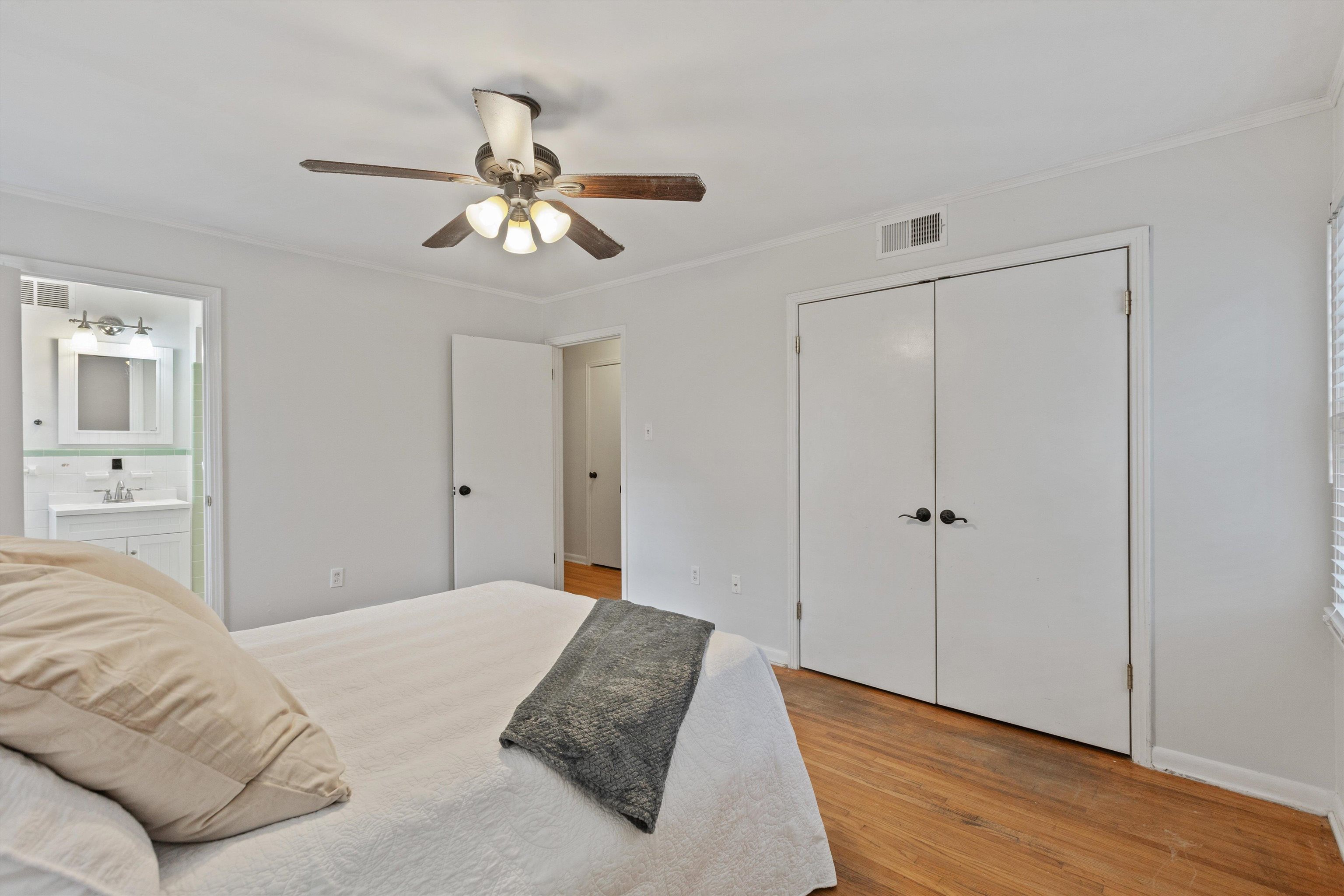 5555 Barfield Road Memphis, TN 38120 - Photo 16 of 23 a bedroom with a bed and a chandelier fan