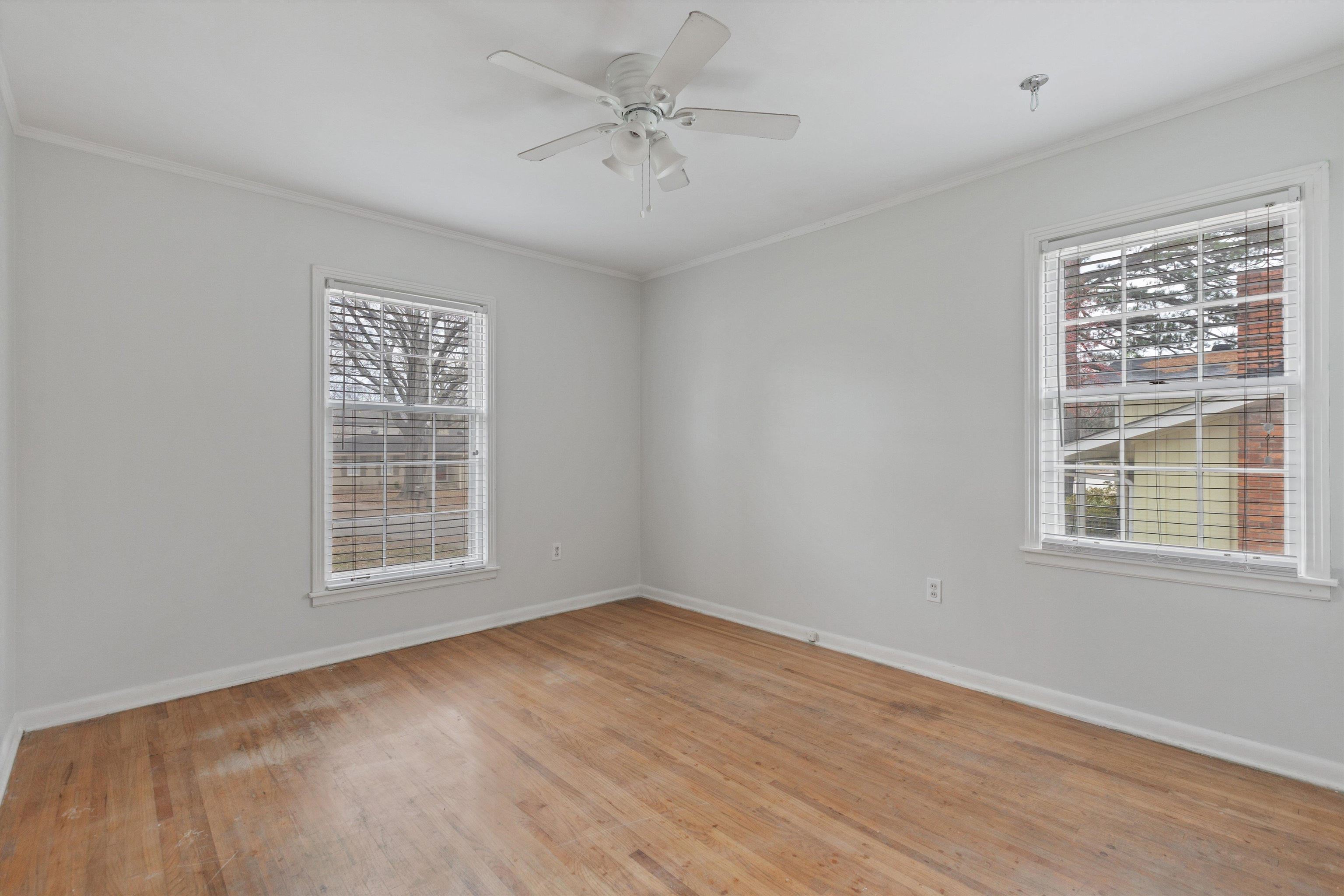 5555 Barfield Road Memphis, TN 38120 - Photo 18 of 23 a view of an empty room with a window and wooden floor