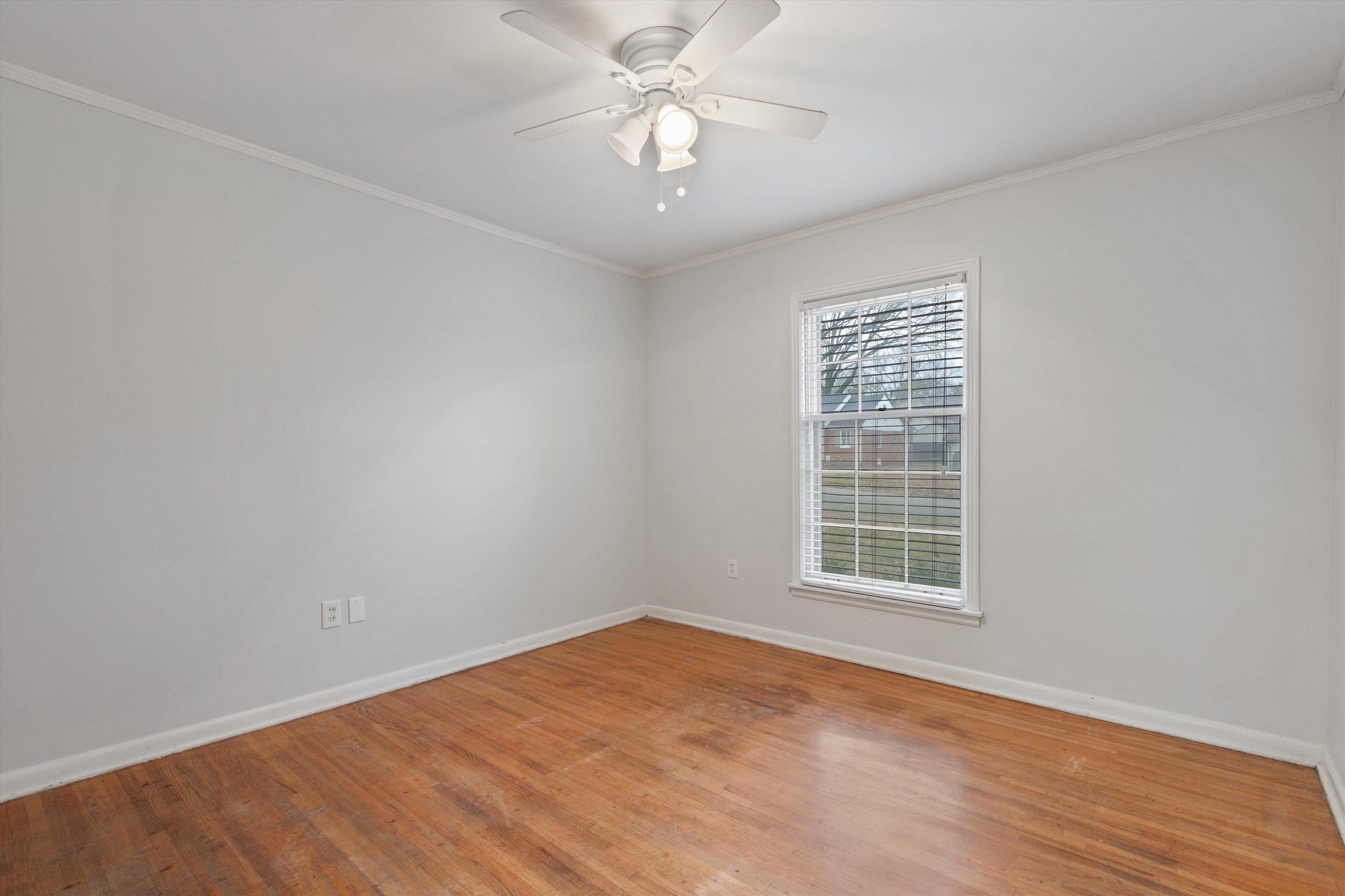5555 Barfield Road Memphis, TN 38120 - Photo 20 of 23 wooden floor in an empty room with a window