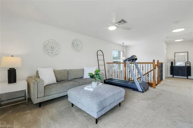 a living room with furniture a table and a chandelier