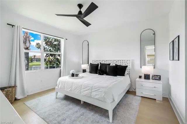 a bedroom with a large bed and a window