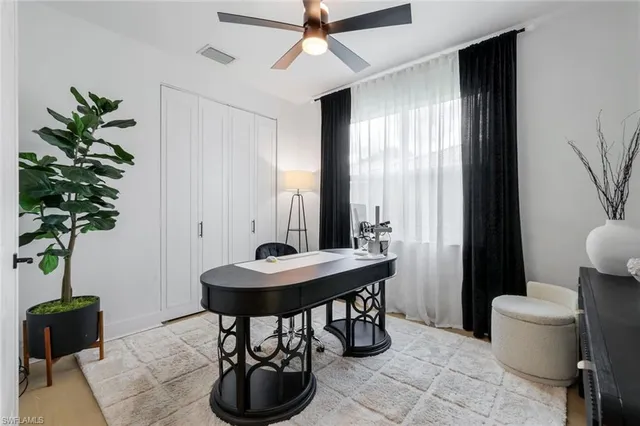 a view of a livingroom with furniture and a potted plant