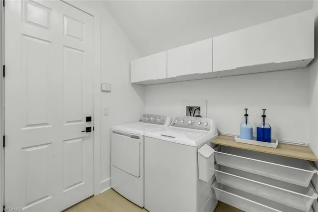 a view of storage and utility room with washer and dryer